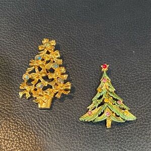 2 sparkly Christmas tree pins. 1 Avon with bows; 1 green enamel with rhinestones
